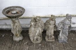 Three reconstituted stone garden figures and a bird bath.