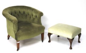 An early 20th century tub chair and a footstool.