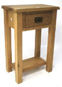 A contemporary oak bedside/side table.