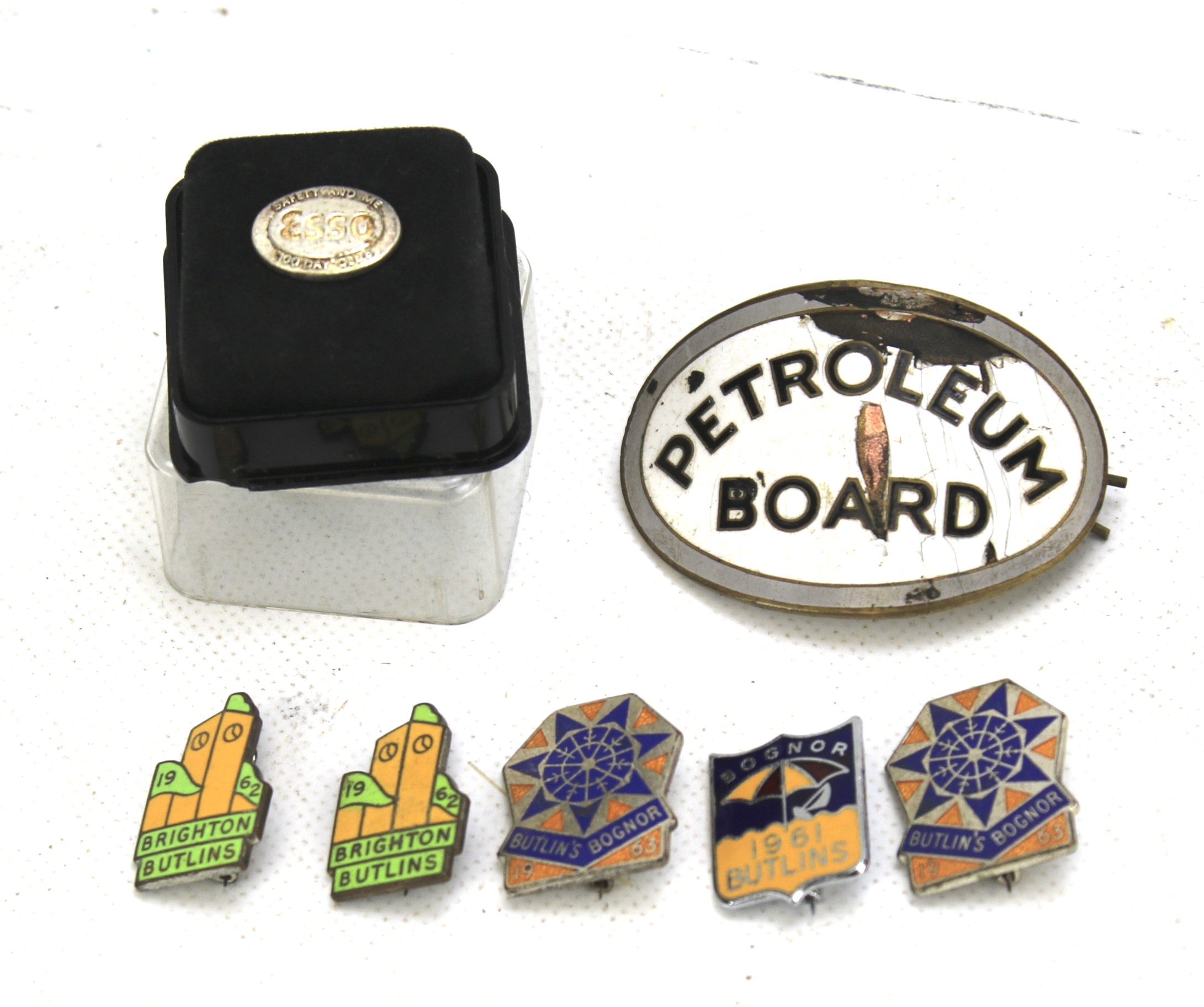 A collection of enamel driving badges.