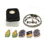 A collection of enamel driving badges.