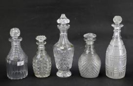 Five glass decanters.