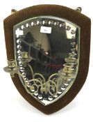 A late 19th century shield shaped betrothal wall mirror with two candlestick sconces.