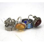 A selection of five silver rings. Three being gem set, approximately 23.