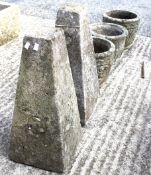 A pair of stone garden planters and another together with two stone obelisks.