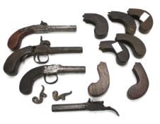 An assortment of 19th century pistol parts.