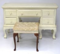 A 20th century white painted dressing table and a stool.
