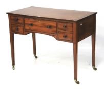 An Edwardian ebony inlaid mahogany desk.