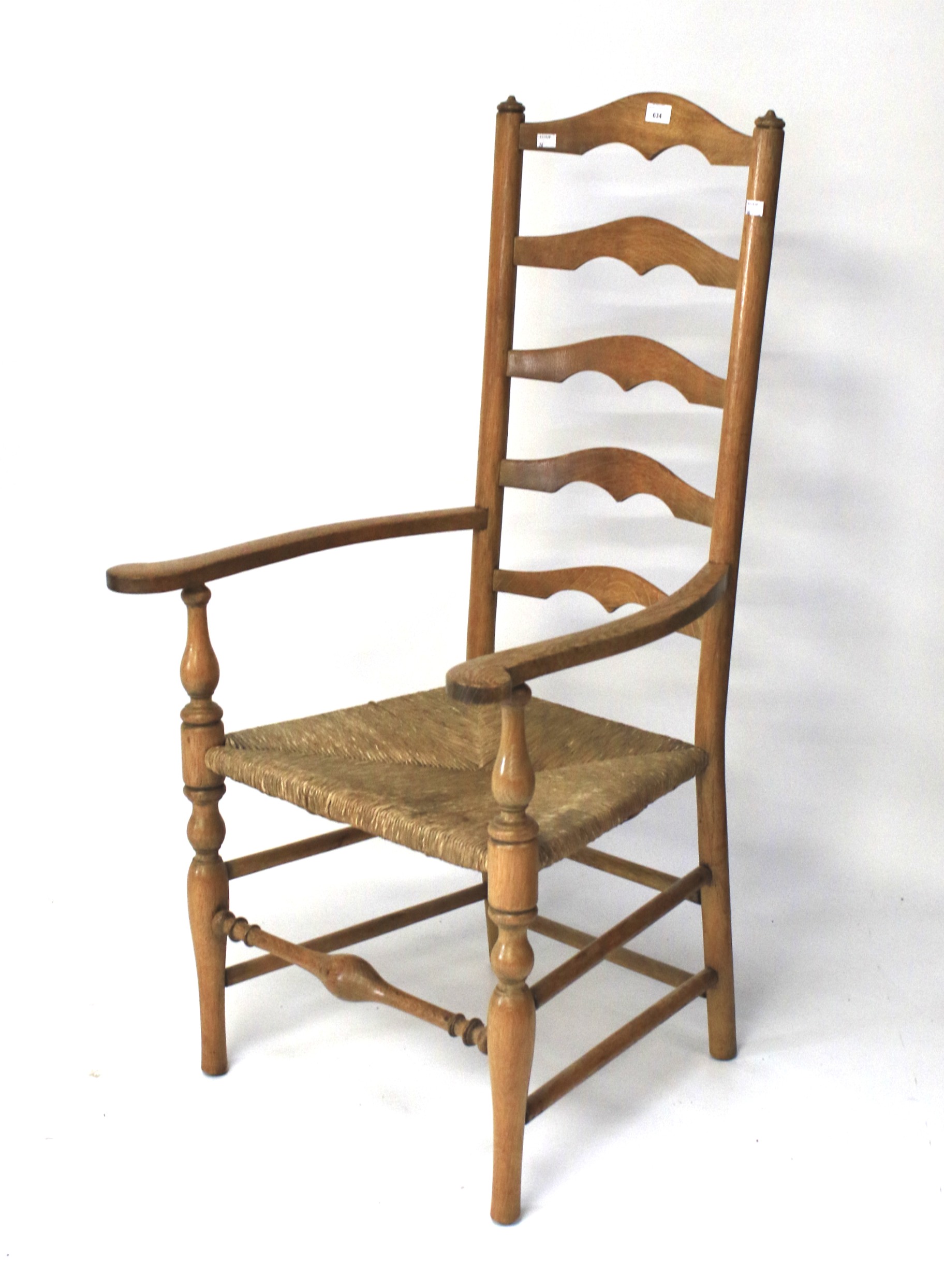 A 20th century oak ladder back kitchen chair.