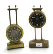 Two similar English brass gravity clocks.