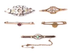 A group of for Victorian and later gold bar brooches and a silver and gilt brooch.