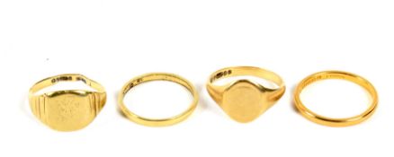 Four yellow metal and gold rings. Comprising a 22ct gold wedding band