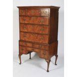 An Old reproduction elm veneered Queen Anne style chest-on-stand.