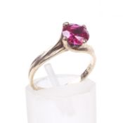 A modern synthetic-ruby single stone dress ring.