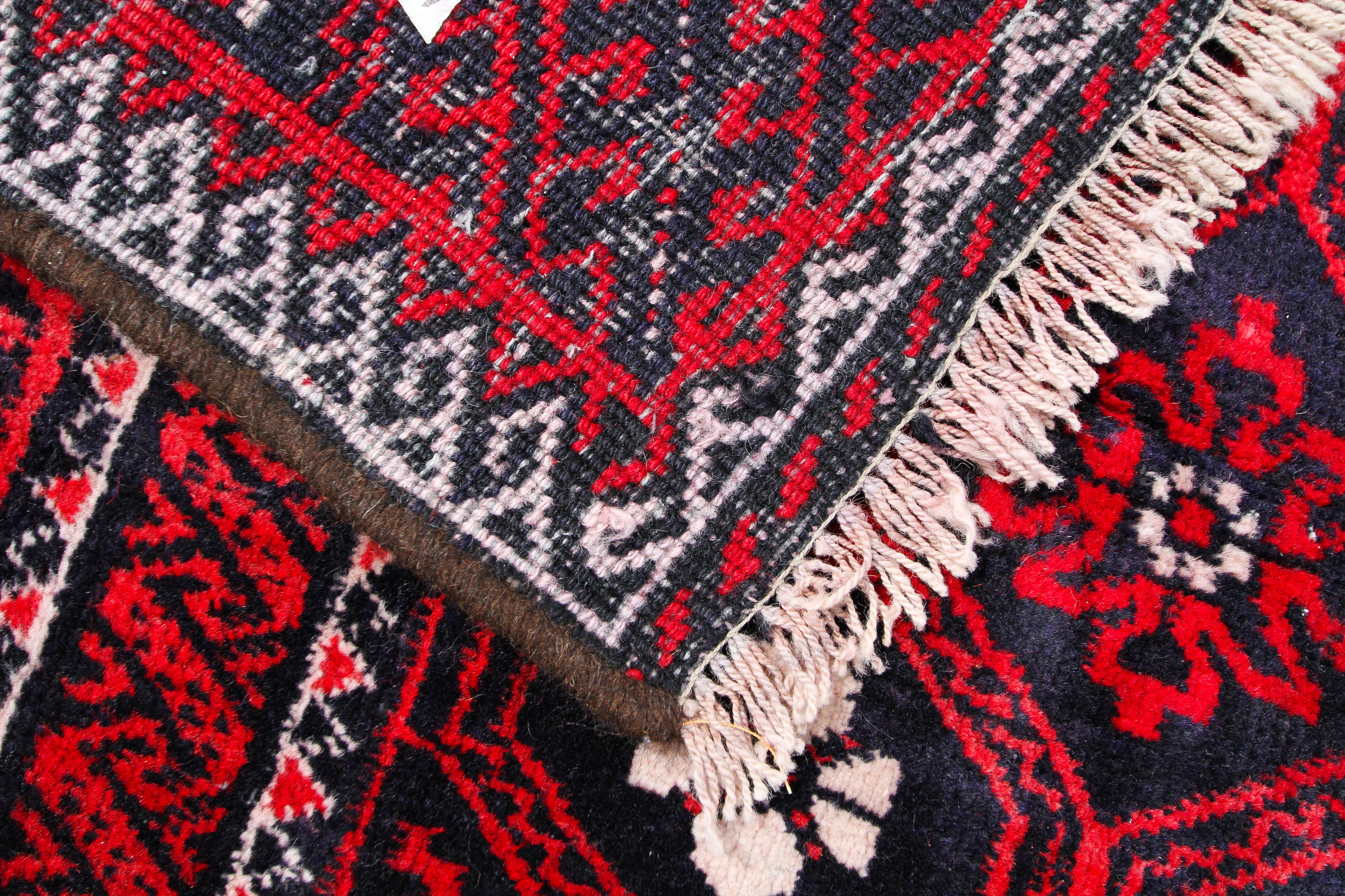 A Blooch red ground rug. - Image 2 of 3
