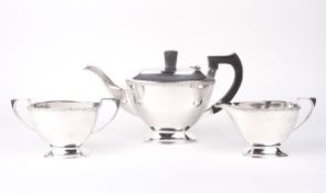 A silver three piece tea set.