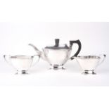 A silver three piece tea set.