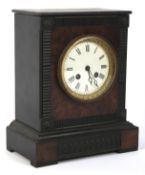 An ebonised wooden case mantle clock The enamel, face with Roman numerals,