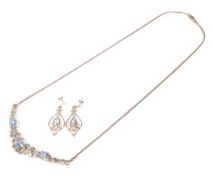 A modern Italian 9ct gold, treated blue topaz and diamond necklace and earing set.