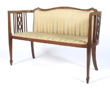 An Edwardian mahogany and string inlaid settee.