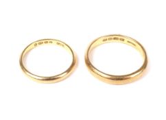 Two 22ct gold wedding bands. Comprising; a court shaped band with hallmarks for Birmingham 1924,