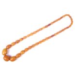 A amber oval bead necklace, the 46 varigated butterscotch-coloured oval beads