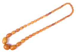 A amber oval bead necklace, the 46 varigated butterscotch-coloured oval beads