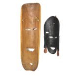 Two mid-century Solomon Island carved wooden masks.