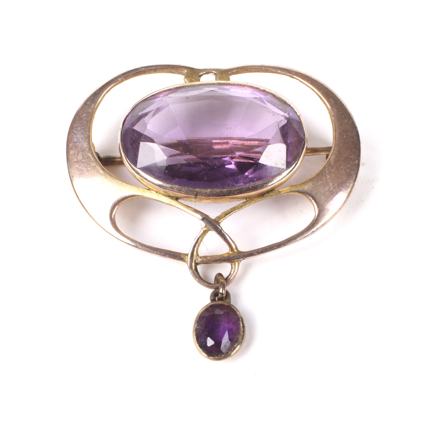 An Art Nouveau rose gold and amethyst open brooch.