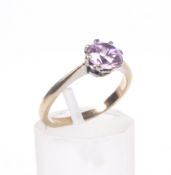 A vintage yellow metal and pink cubic zirconia single stone ring.