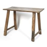 An oak table. The rectangular top on rectangular plank supports joined by stretchers, L107cm x D49.