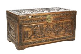 A heavily carved Asian camphor wood chest.