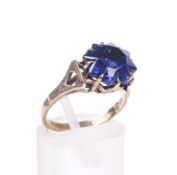 A 9ct gold and synthetic-sapphire single stone ring.