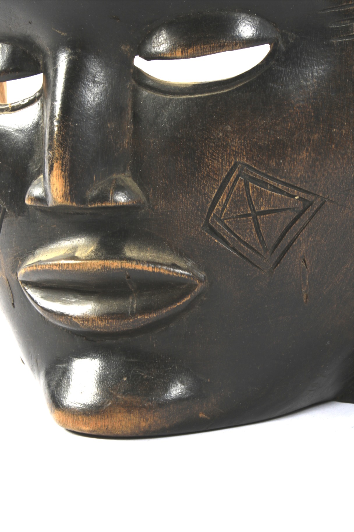 A 20th century large carved wooden tribal wall mask. - Image 2 of 2