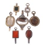 Six late George III and later hardstone set watch keys and another.