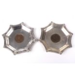 A pair of silver pin dishes with a 1901 & 1902 penny to the well.