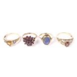 Four vintage and modern gold and gem set rings.