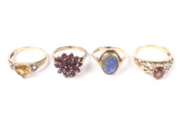 Four vintage and modern gold and gem set rings.