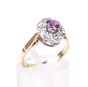 An 18ct gold, ruby and diamond shaped-oval cluster ring,