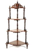 A Victorian four tier serpentine shaped watnot.