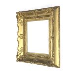 A fine 19th century wood and plaster gilded swept picture frame.