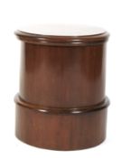 A Victorian circular mahogany pedestal Commode. With rising lid enclosing a seat and porcelain bowl.