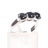 An 18ct white gold and black diamond three stone ring.