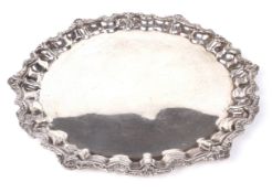 An Egyptian silver card tray. Of scalloped circular form with shell and foliate rim, with .