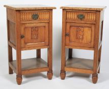 A pair of marble topped oak bedside cabinets.