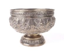 An Indian white metal embosed pedestal bowl.