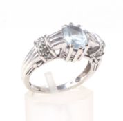 A modern 9ct white gold and topaz dress ring.