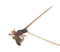 An early 20th century gold, ruby, rose diamond 'fly' stick pin.
