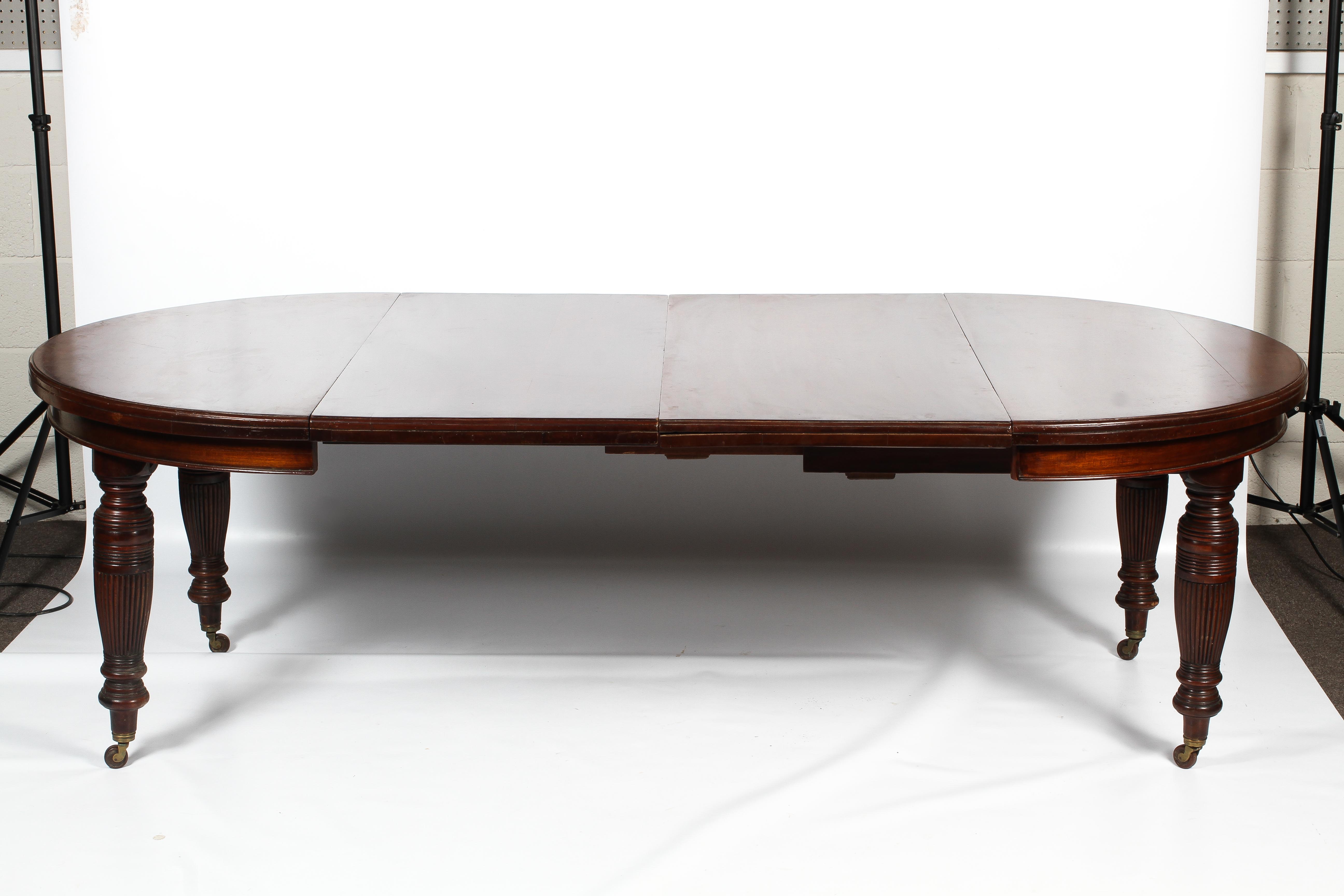 A Regency oval mahogany extending dining table. - Image 4 of 5