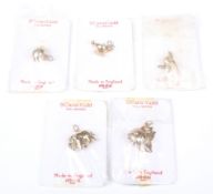 Five 9ct gold charms.